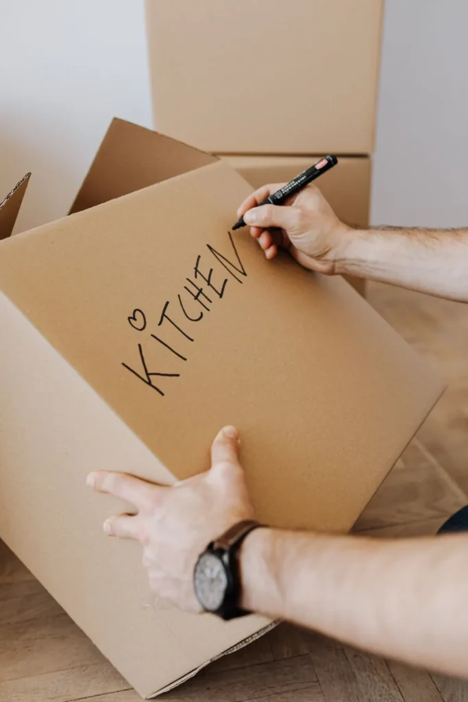 Labelling a packed cardboard box with a marker pen