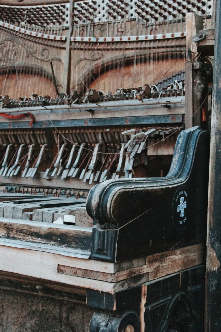 Open grand piano showing the strings, frame and keys