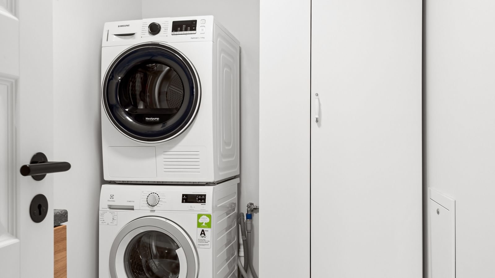 Contemporary utility room with stacked washer and dryer