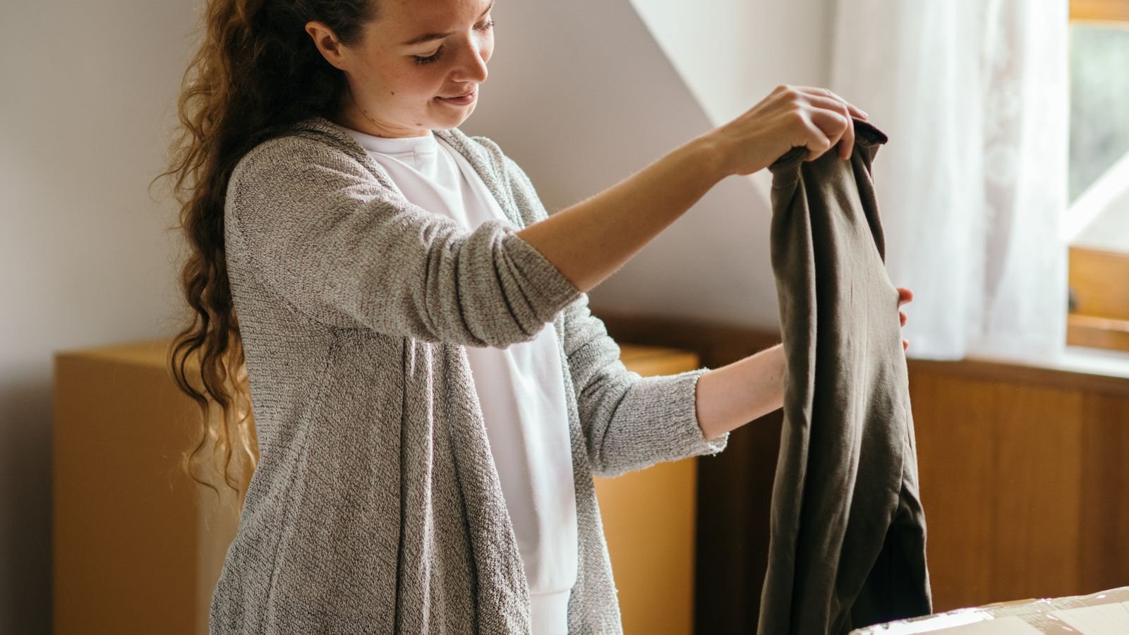 Packing household items into cartons