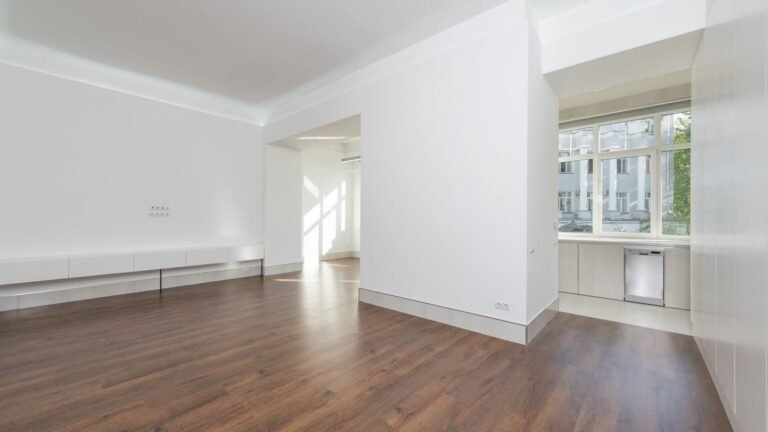 Plain empty bedroom with wooden flooring