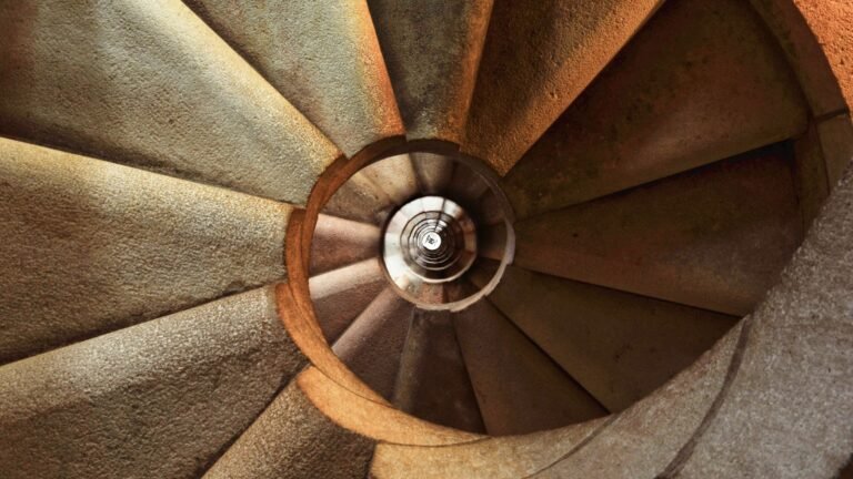 Close-up view of a spiral stone staircase, similar to those found in Edinburgh tenement closes